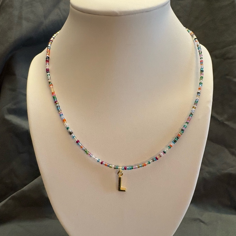 Hand beaded necklace with “L” charm